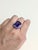 Command attention with a 11.96ct tanzanite ring in solid 14k gold, adorned with genuine diamond accents and a graceful...