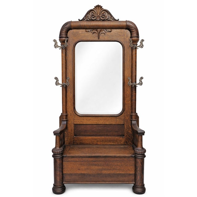 An exceptional and commanding antique American hall tree crafted in richly figured quarter-sawn tiger oak, dating to the...