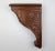 A cherry wood corbel bracket of deep reddish-brown, carved with Neoclassical acanthus leaf decoration in relief. This...