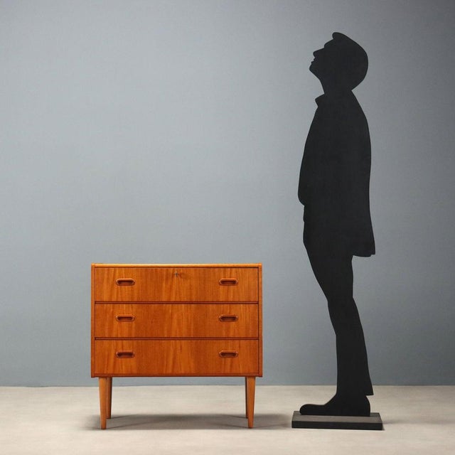 A 1960s Northern European teak chest of drawers, featuring clean, functional lines typical of Scandinavian design of the...