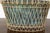 A rustic French oval shaped cachepot from the midcentury period with white painted metal frame surrounding a blue green...