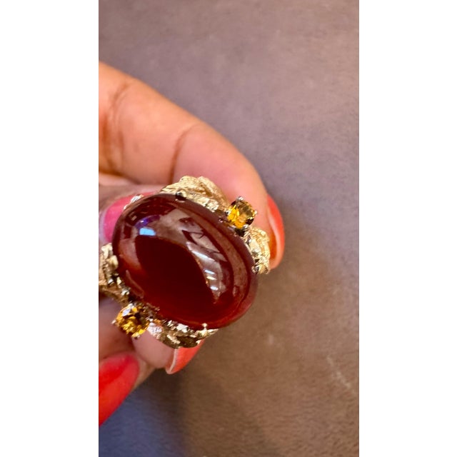 This classic cocktail ring features a stunning oval natural Garnet cabochon with two stones of Citrine stones . The Garnet...