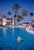 At La Coquille Club by Toni Frissell Mrs Guinness of Palm Springs adjusts her swimming cap in the pool at La Coquille Club...