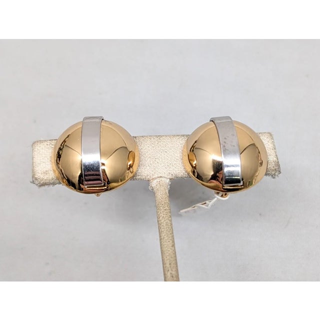 Circa 1975 goldtone round domed with a rhodium plated stripe down the middle clip and screw back earrings. Marked...