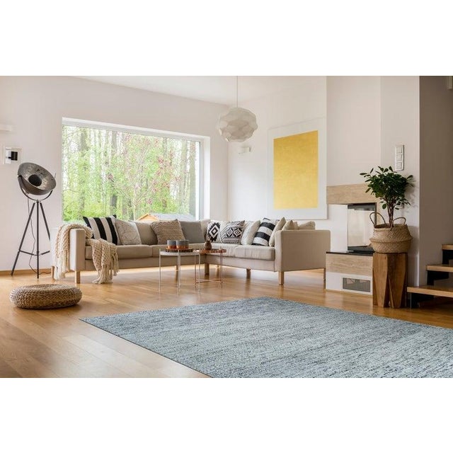 This gray hand knotted pile rug is crafted from silk and originates from India. It features a contemporary style defined...