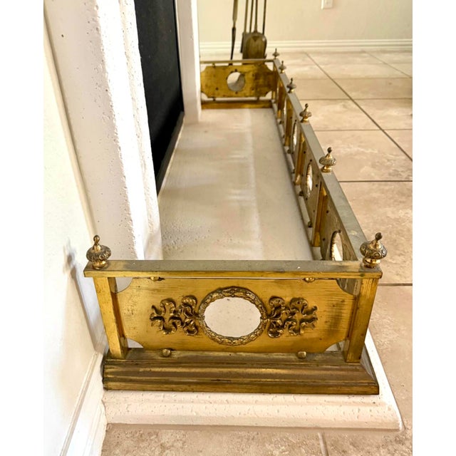 Offering a quality 19th century Victorian ornate brass fender having original brass finials to the top with very ornate...