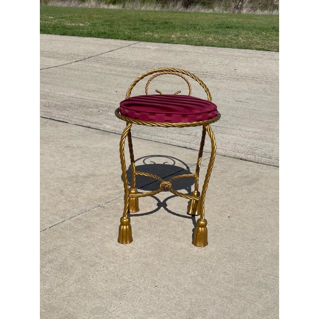 A vintage gilt metal "rope and tassel" design stool. Italy, circa 1960.
