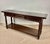 Elegant 1930s Spanish console table crafted in walnut with a warm rich patina. The piece features three drawers across the...