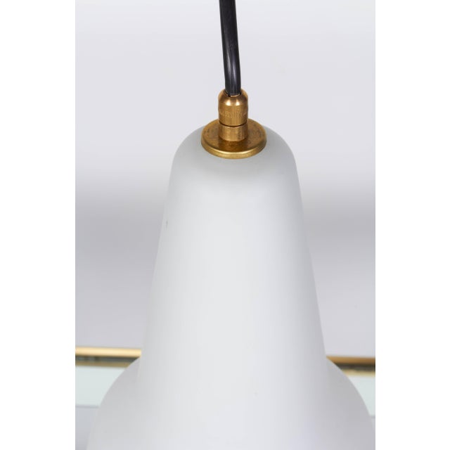 One of a group of Italian handblown pendant light, circa 1950. Glass shade is layered with a clear satin finished over...