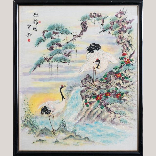 This oil painting on canvas presents a serene East Asian landscape featuring two elegant cranes set within a mountainous...