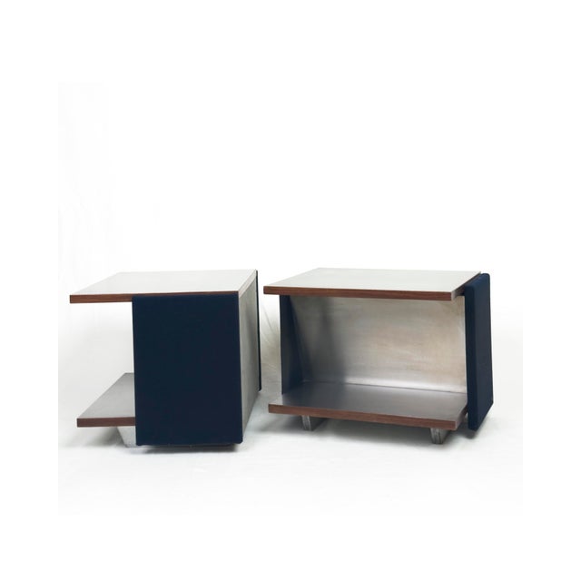 A striking pair of Italian side tables from the 1970s, executed in wood clad with brushed stainless steel and finished...