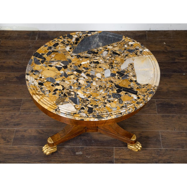 A French Napoléon III period mahogany center table from the mid 19th century with colorful marble top, pedestal base and...