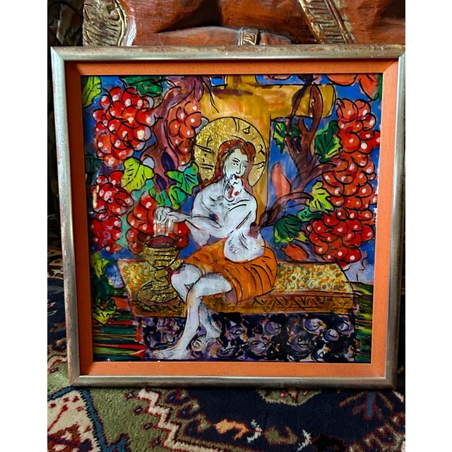 A haloed saint seated among vines heavy with fruit, painted by hand on the reverse of the glass and picked out in gold....