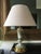 This elegant and glamorous table lamp in light green porcelain and brass, is one of the latest pieces manufactured by a...