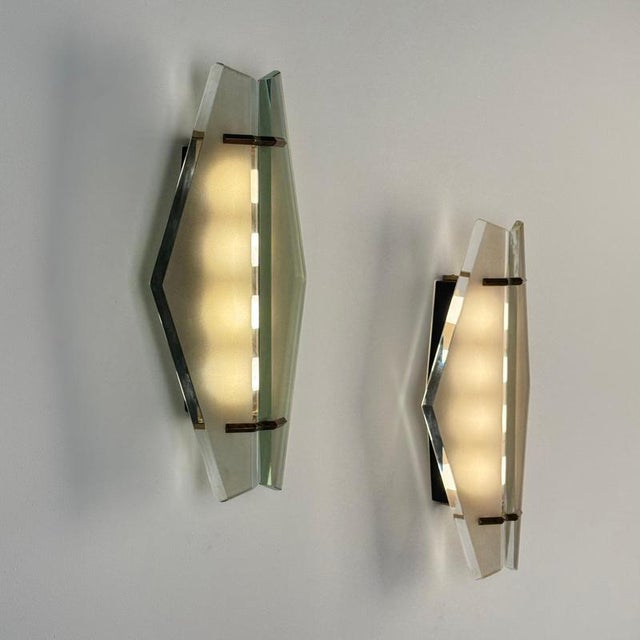 A rare and exquisitely preserved pair of model 1943 wall lights by max ingrand for fontana arte, produced in the 1950s....