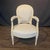 Elegant pair of 19th century French Louis XVI fauteuils with carved painted frames featuring fluted, tapered legs, stop-...