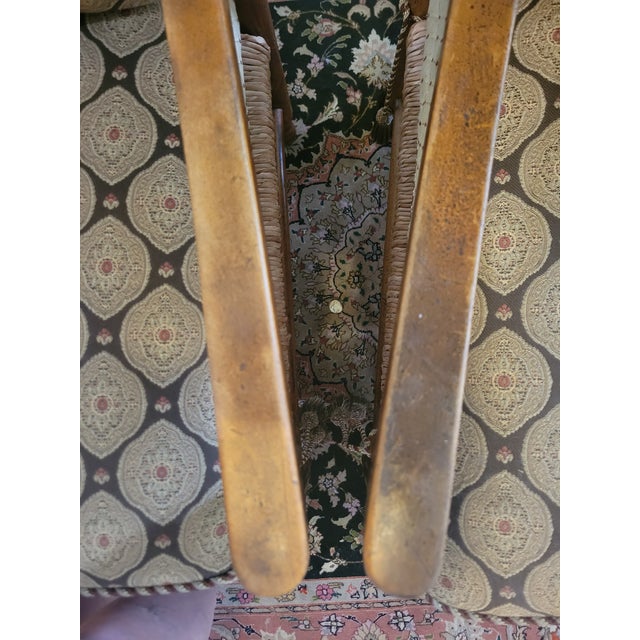 Charming pair of vintage wooden ladder‑back chairs with curved back slats, warm natural wood, and hand‑woven rush seats....