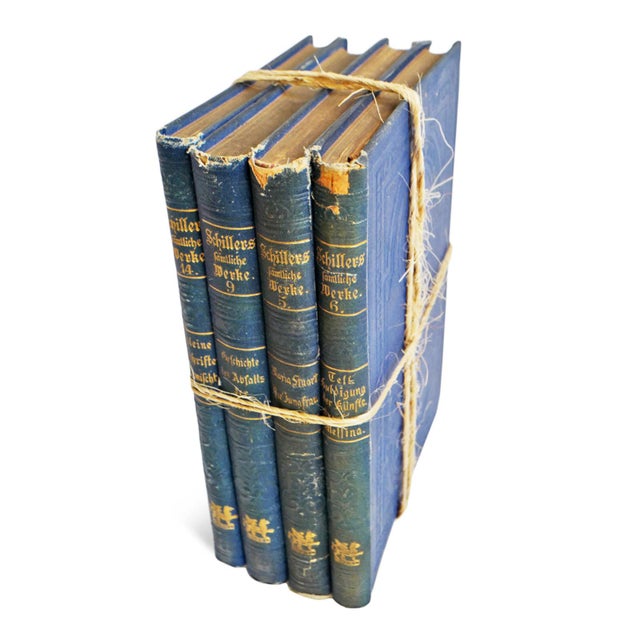 Antique book bundle in beautiful blue tones. Various old books with aged leather and cloth bound covers wrapped in thin...
