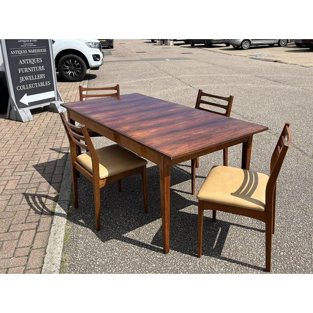 Mid Century Rosewood Dining Table & 4 Teak Dining Chairs. Table :- 167 cms in length, 84 cms wide, 72.5 cms tall. Chairs...