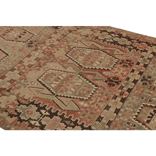 Originating from Turkey between 1940-1950, this vintage Esme wool Kilim rug features a high-quality flat-weave and a...