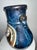 Ceramic vases featuring hand-painted panda panels set within a bamboo landscape. The vases have a deep blue-black high-...
