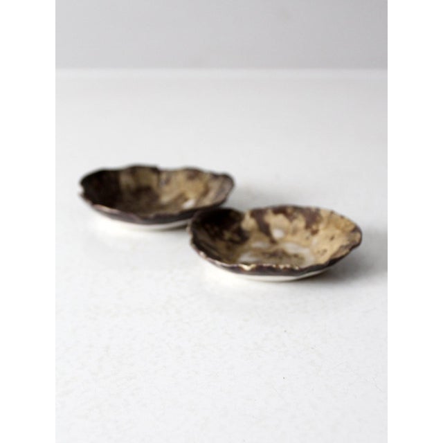 Embrace the beauty of imperfection with this set of two vintage handmade pottery plates. Each piece features organic,...