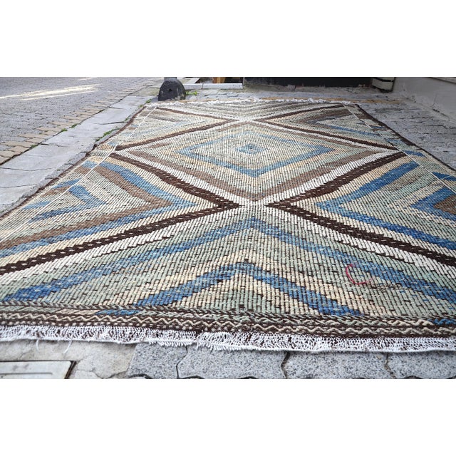 This is a vintage Turkish Anatolian kilim rug from the 1960s. The piece was hand-woven.