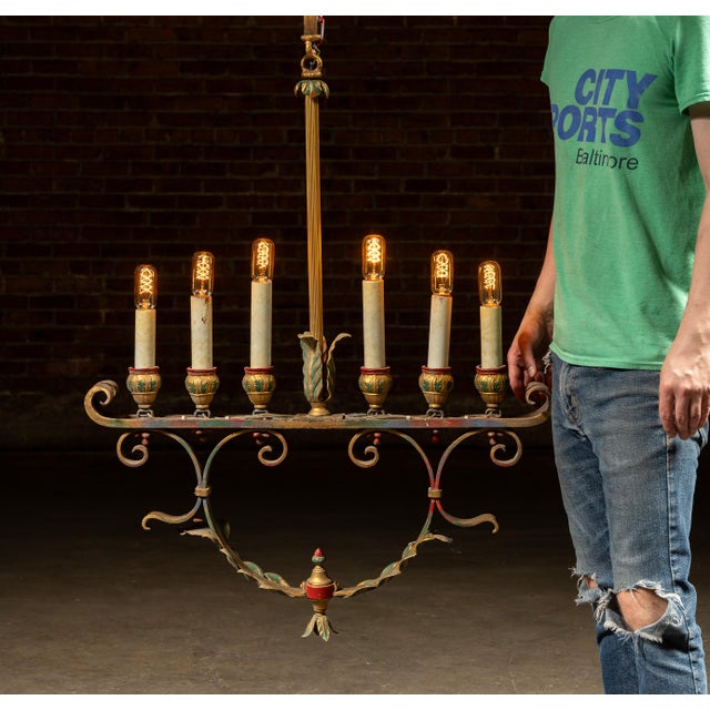 Mediterranean Revival chandelier with polychrome finish. Hand-forged iron frame with scrolling arms supports six candle-...