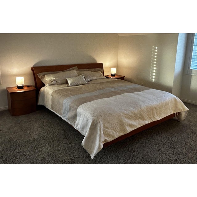 Dania Wood California King Sleigh Bed. This distinctive Scandinavian-style platform frame is crafted with a curved cherry...