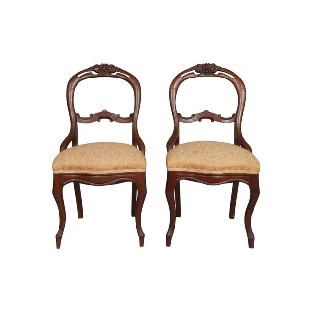 A pair of Eastlake period, American made, balloon back chairs. Petite frames are made of cherrywood, with balloon shaped...