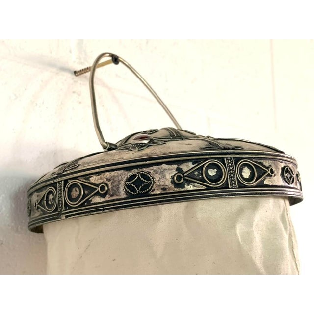 Originating from the historic metalworking traditions of Sana'a, Yemen, this striking piece showcases a collapsible...