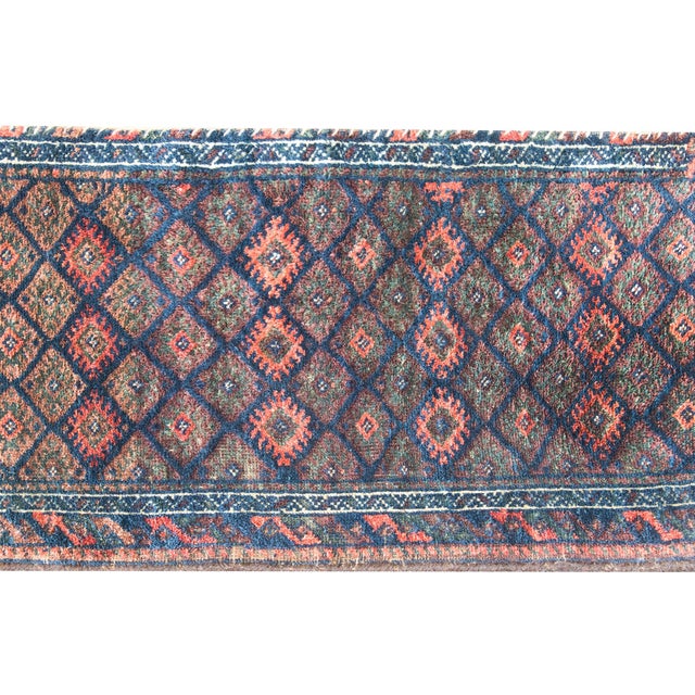 This early 20th-century Persian Baluch bag face rug is a striking example of nomadic artistry from the border regions of...