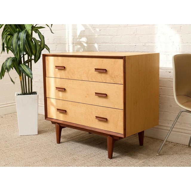 A handsome lowboy dresser featuring three wide drawers with beautifully figured birdseye maple fronts. The light, richly...