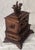 A beautifully expressive c.1880 Black Forest jewelry box, richly carved from warm walnut and crowned with a tender pair of...