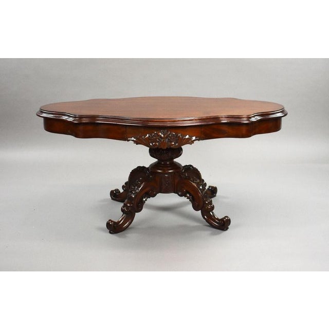 A superb 19th century carved mahogany coffee table of striking form and fine craftsmanship. The shaped moulded top sits...