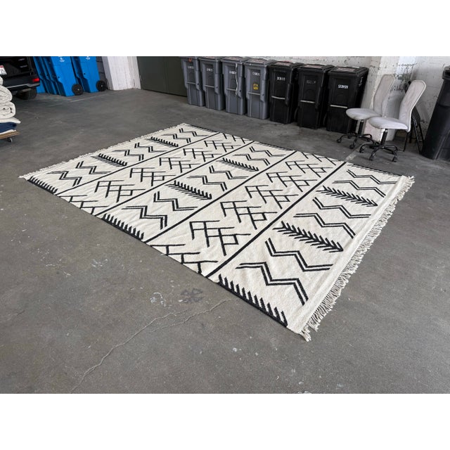 Design Plus Gallery presents a 9 ft 2 in × 12 ft 3 in Coulter Graphic Wool Area Rug from Four Hands. This area rug...
