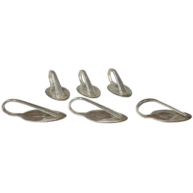 A wonderfully inventive set of six place card holders, individually fashioned from vintage Rogers silver-plated spoons and...