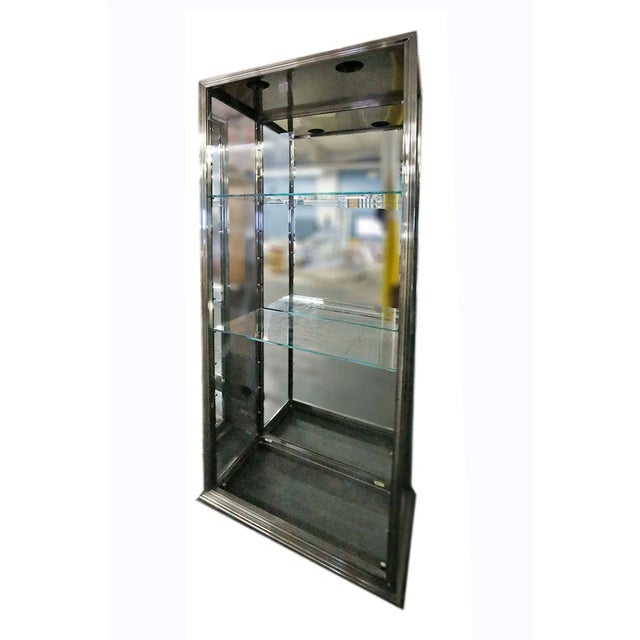 Vintage modern chrome and glass vertical showcase with glass shelves and mirrored back.