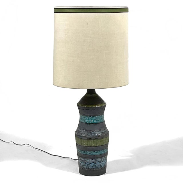 A beautiful example of Bitossi ceramics, this table lamp has a base covered in bands of Londi's signature decoration in...