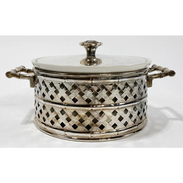 Vintage lidded serving crock with silver plate handled faux bamboo frame. Ceramic serving bowl itself measures 8.5"dia x...