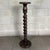 Slender and elegant solid wood floor-standing pedestal column with a twisted Solomonic column design, a refined piece of...