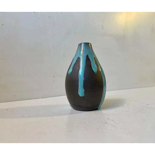 Ceramic vase decorated with petrol green drip-glaze. Designed by the danish ceramist Helge Østerberg and manufactured at...