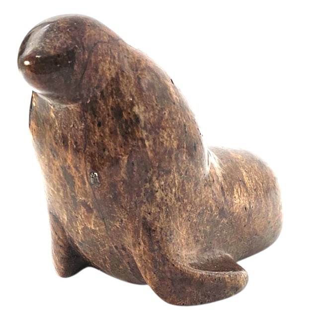 Fashioned from enduring granite, this seal figurine carries the quiet weight of the northern coasts. Its surface, worked...