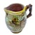 Antique majolica grape vine and barrel creamer with vine handle. Marked "SIX" on the underside.
