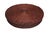 A set of six circular woven raffia placemats with matching woven storage basket. Mats are a deep reddish-brown color with...