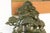 A vintage Chinese sculpture intricately carved from rich green jade, featuring the Taoist deity Shou Lao (symbol of...