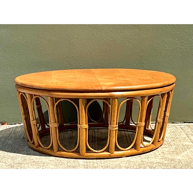 Embrace the organic elegance of this vintage looped rattan coffee table, a quintessential piece for any coastal or...