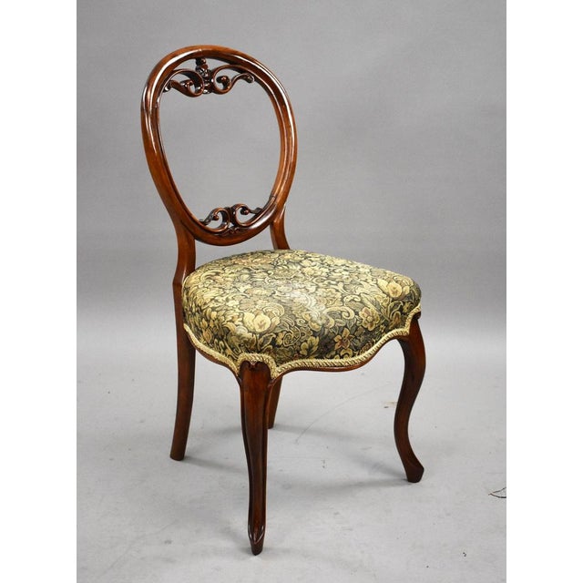 Set of six Victorian dining chairs. Crafted from warm toned walnut, these chairs feature the classic balloon back...