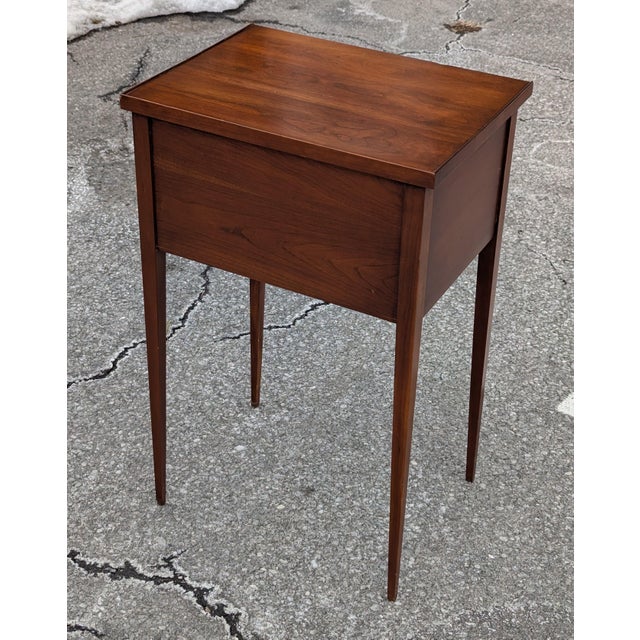 The Henkel Harris nightstand from the Antique Virginia Galleries collection is a masterclass in refined craftsmanship....