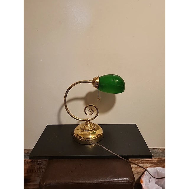 This is a tall and elegant vintage banker’s lamp with the classic green glass shade. The brass base makes it a timeless...